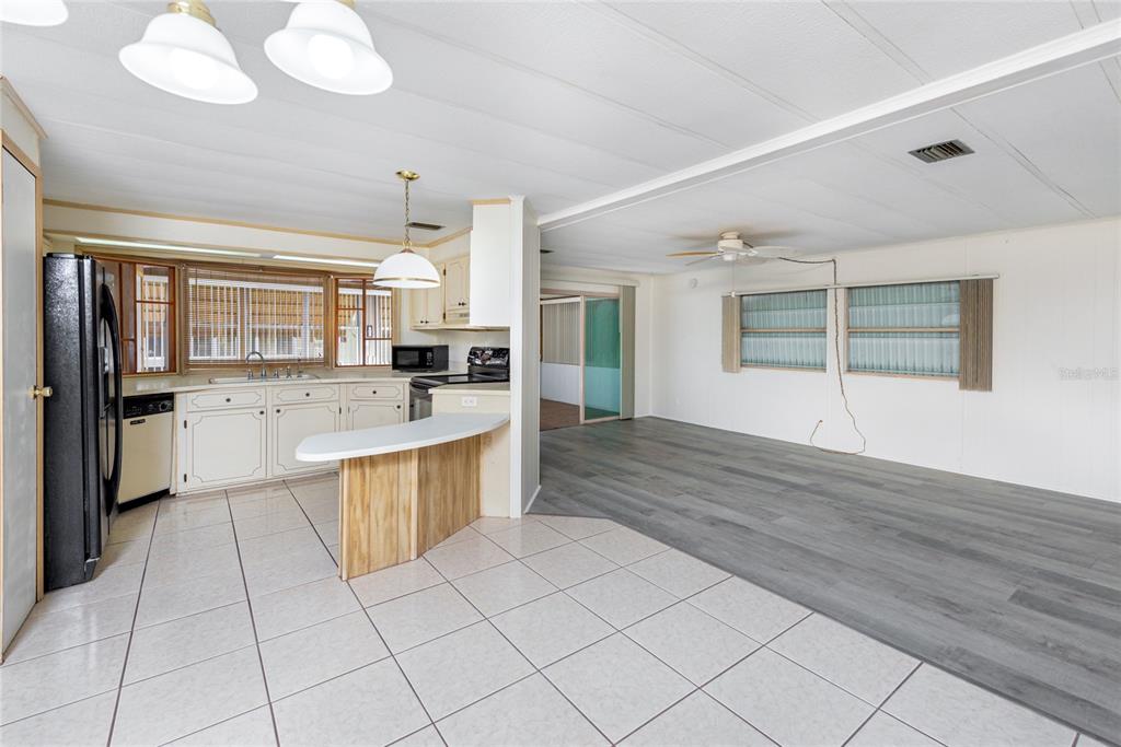 2542 Longpine Lane St. Cloud, FL 34772 - Photo 12 of 35 a large kitchen with stainless steel appliances kitchen island granite countertop a sink and cabinets