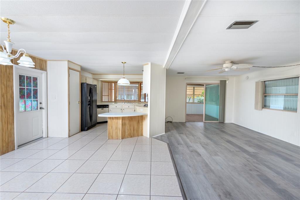 2542 Longpine Lane St. Cloud, FL 34772 - Photo 13 of 35 a large kitchen with stainless steel appliances kitchen island a large counter top and a refrigerator