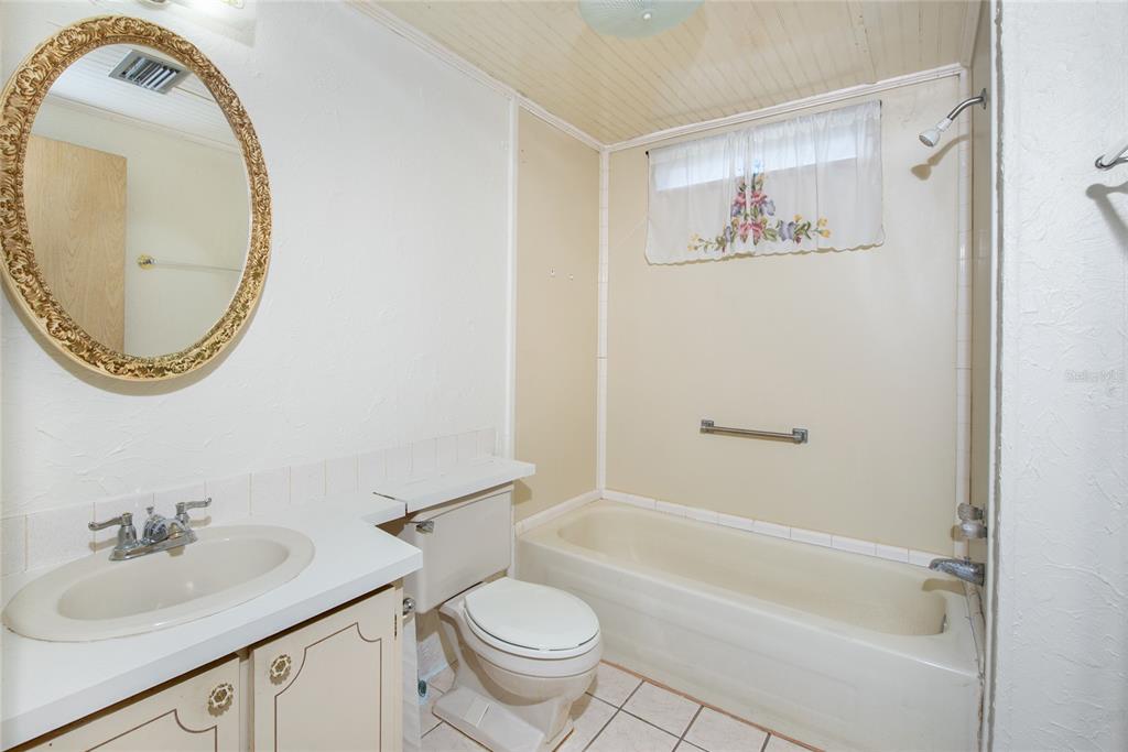 2542 Longpine Lane St. Cloud, FL 34772 - Photo 17 of 35 a bathroom with a sink and a mirror
