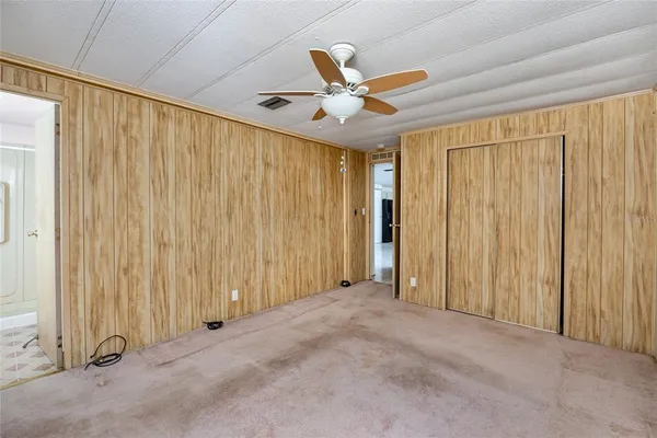 a view of a livingroom with a ceiling fan and window