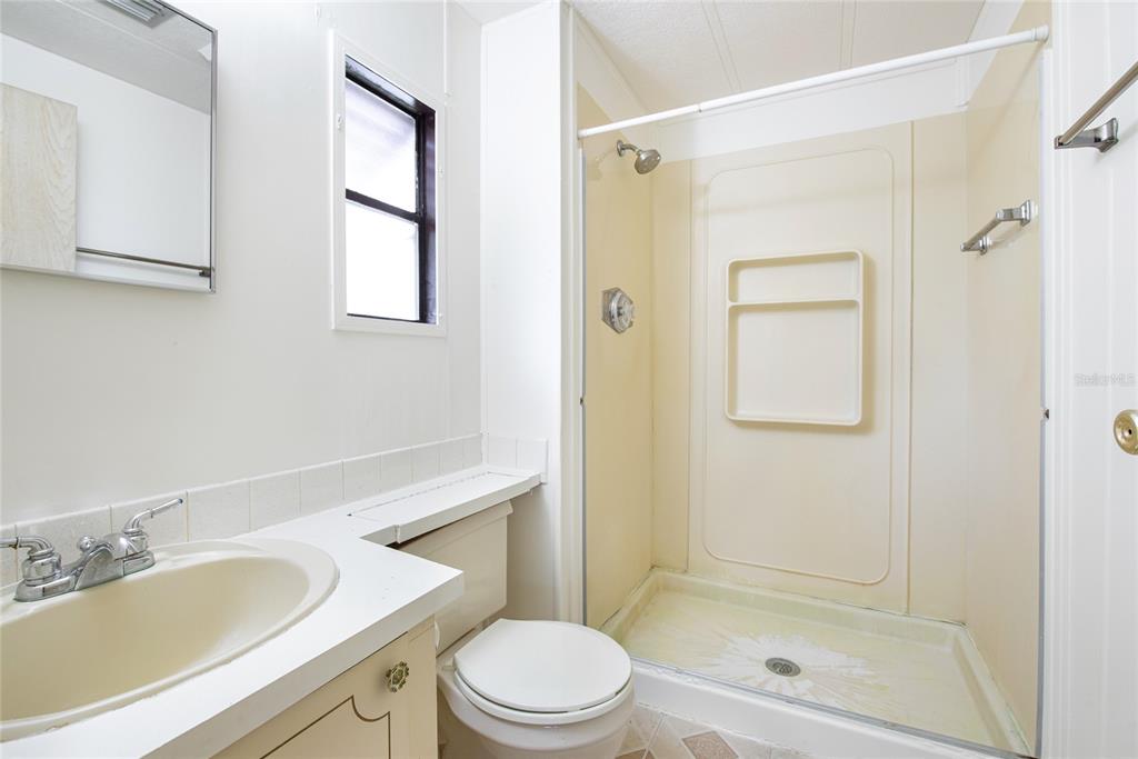 2542 Longpine Lane St. Cloud, FL 34772 - Photo 20 of 35 a bathroom with a sink a toilet and shower