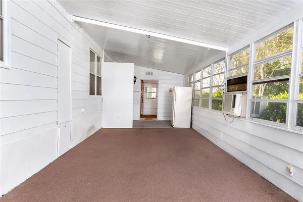 a view of a big room with windows and entryway