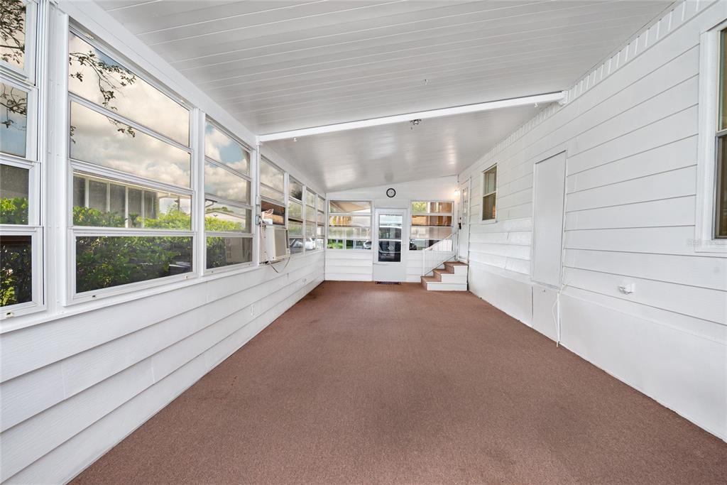 2542 Longpine Lane St. Cloud, FL 34772 - Photo 23 of 35 a view of a hallway with two chairs and a large window