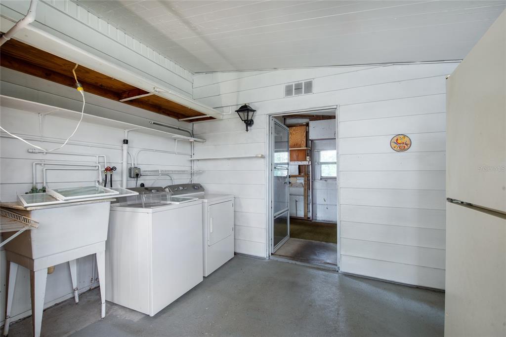 2542 Longpine Lane St. Cloud, FL 34772 - Photo 24 of 35 a kitchen with stainless steel appliances granite countertop a sink a stove and refrigerator