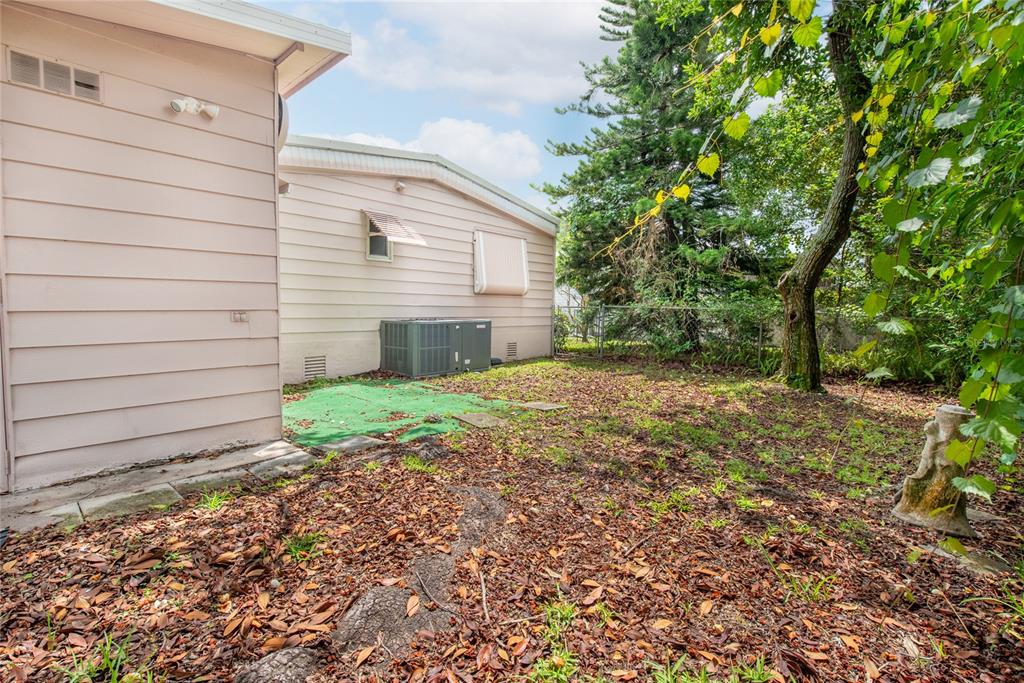 2542 Longpine Lane St. Cloud, FL 34772 - Photo 26 of 35 a view of a backyard with plants and large tree