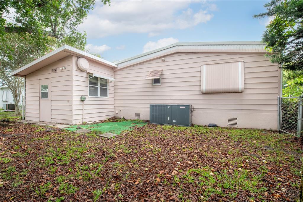 2542 Longpine Lane St. Cloud, FL 34772 - Photo 27 of 35 a backyard of a house with plants and large tree