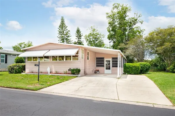 a view of house with yard and green space