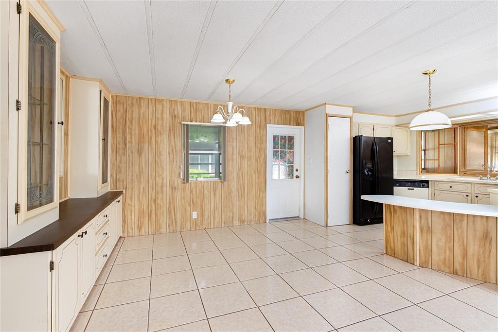 2542 Longpine Lane St. Cloud, FL 34772 - Photo 8 of 35 a view of a kitchen with kitchen island granite countertop a refrigerator and a sink