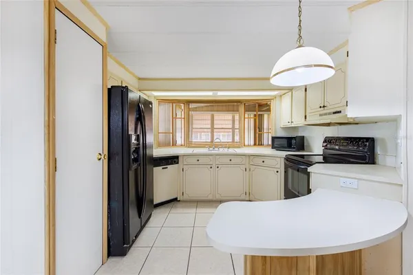a kitchen with stainless steel appliances granite countertop a refrigerator a sink dishwasher a stove with white cabinets