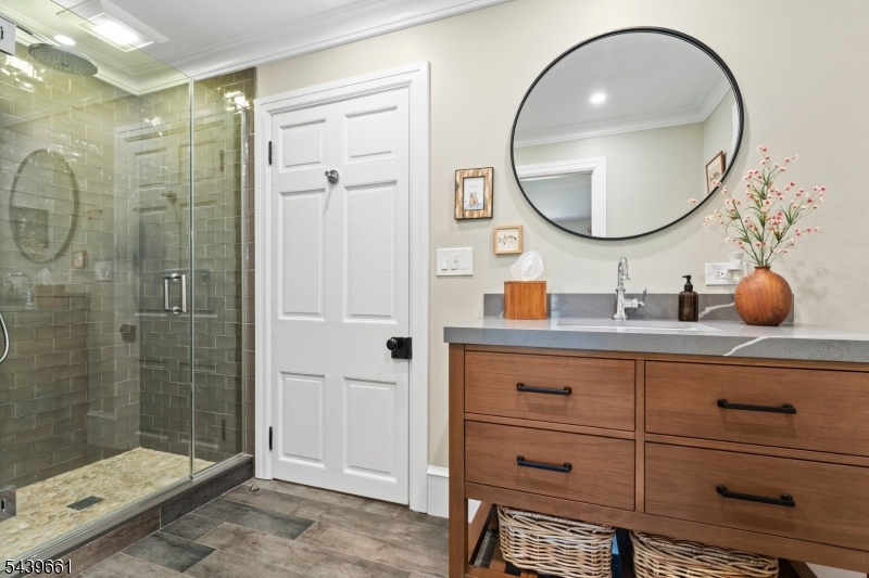 29 Bedens Brook Road Skillman, NJ 08558 - Photo 22 of 50 a bathroom with a sink a mirror a vanity and a shower