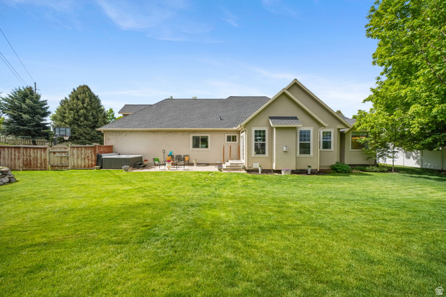 357 South 320 W Street Lindon, UT 84042 - Photo 37 of 41 Expansive green lawn with a stucco exterior home featuring a patio space and privacy fencing