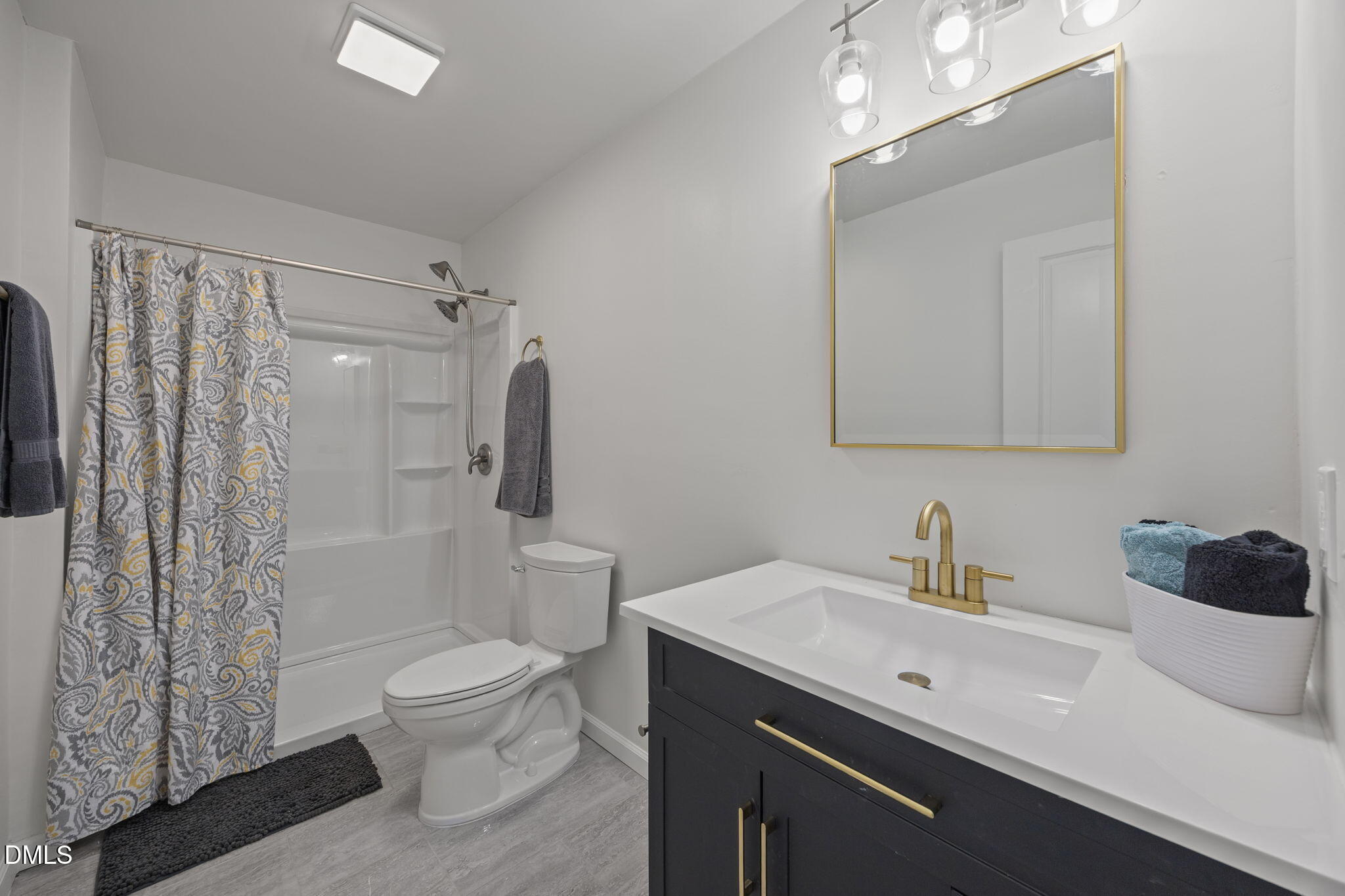 6561 Huntsboro Road Oxford, NC 27565 - Photo 15 of 41 a bathroom with a sink a toilet and shower