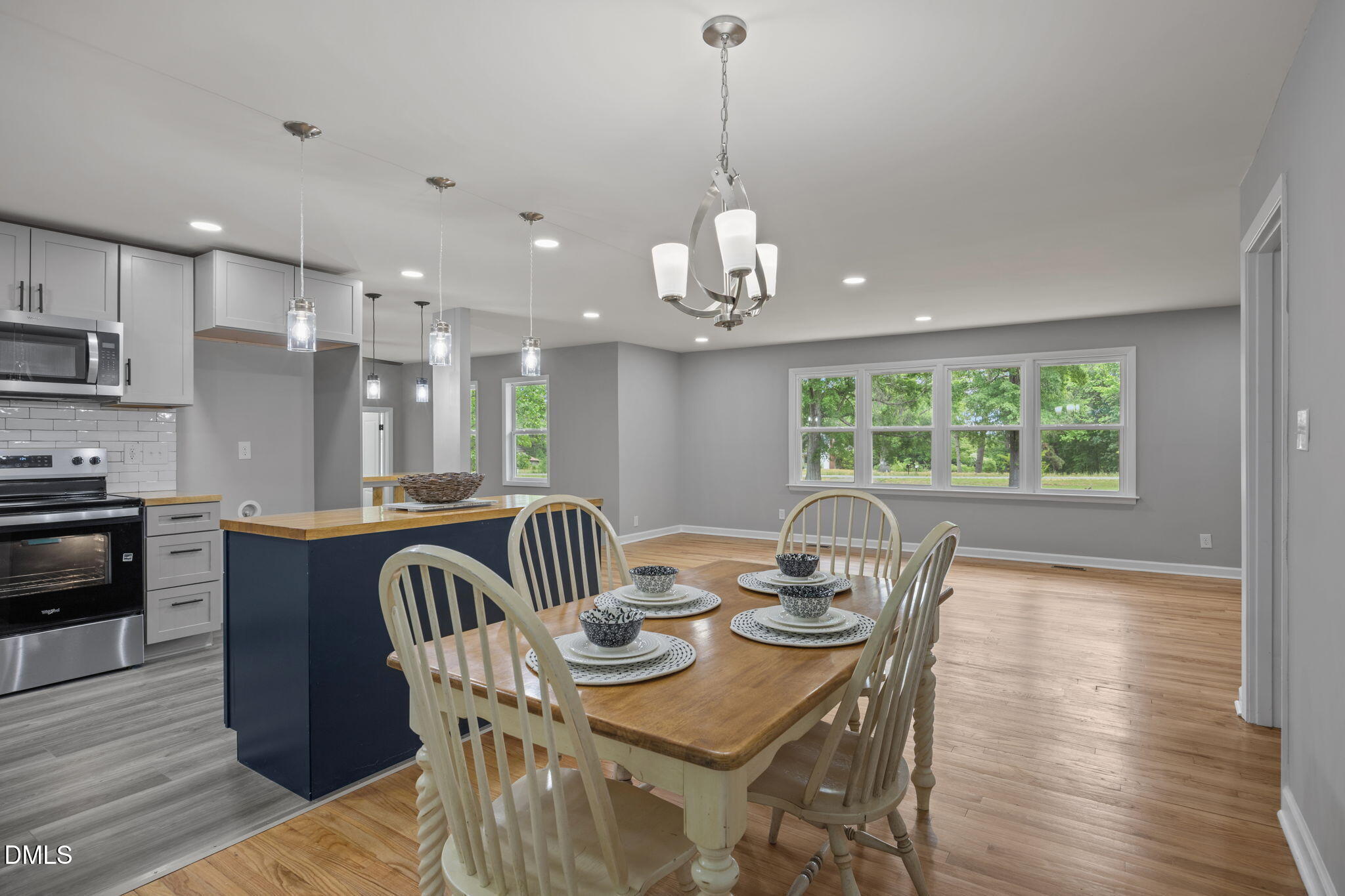 6561 Huntsboro Road Oxford, NC 27565 - Photo 21 of 41 a kitchen with stainless steel appliances granite countertop a kitchen island hardwood floor sink stove dining table and chairs
