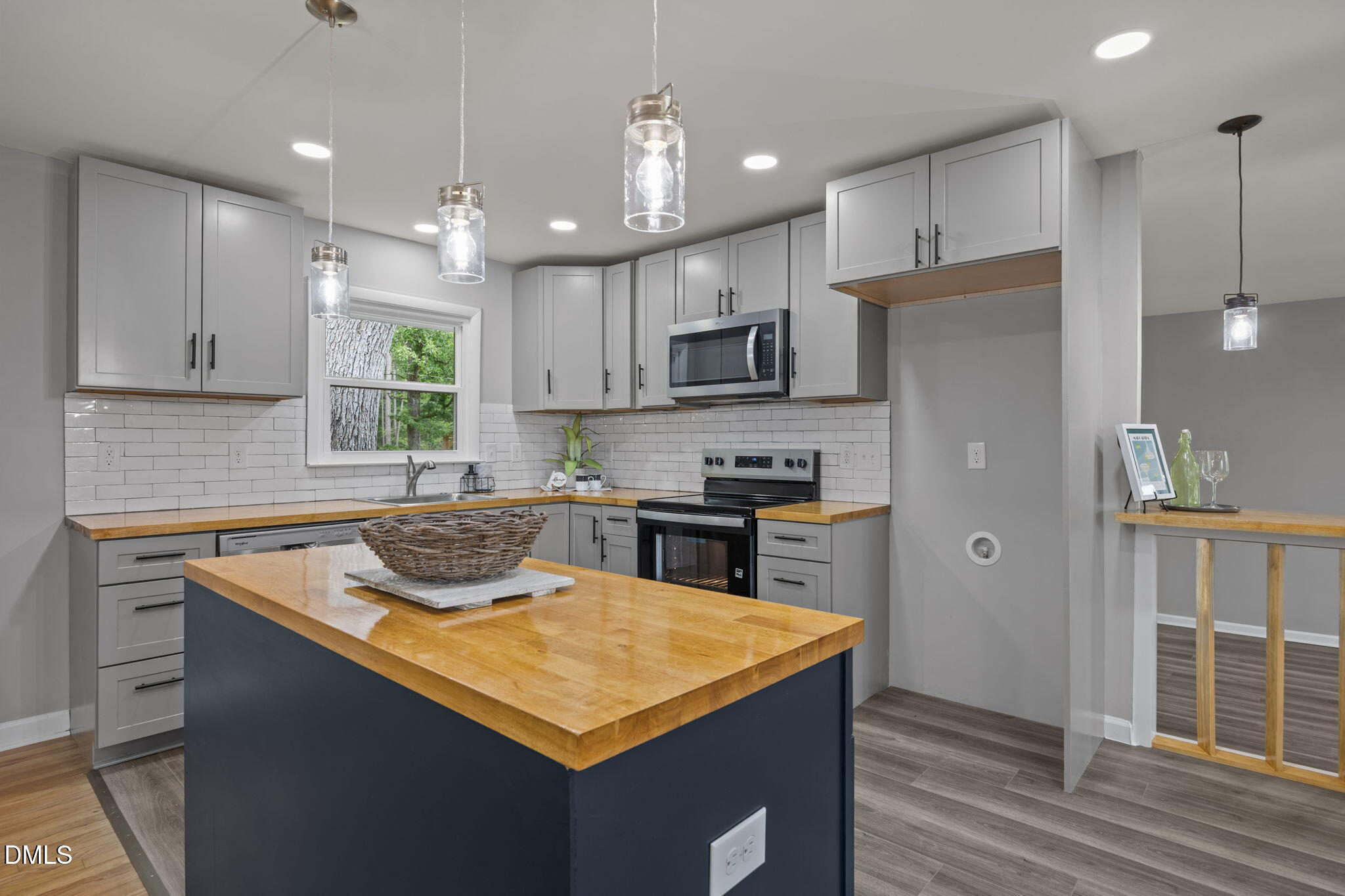 6561 Huntsboro Road Oxford, NC 27565 - Photo 22 of 41 a kitchen with kitchen island granite countertop a sink a counter top space stainless steel appliances and cabinets
