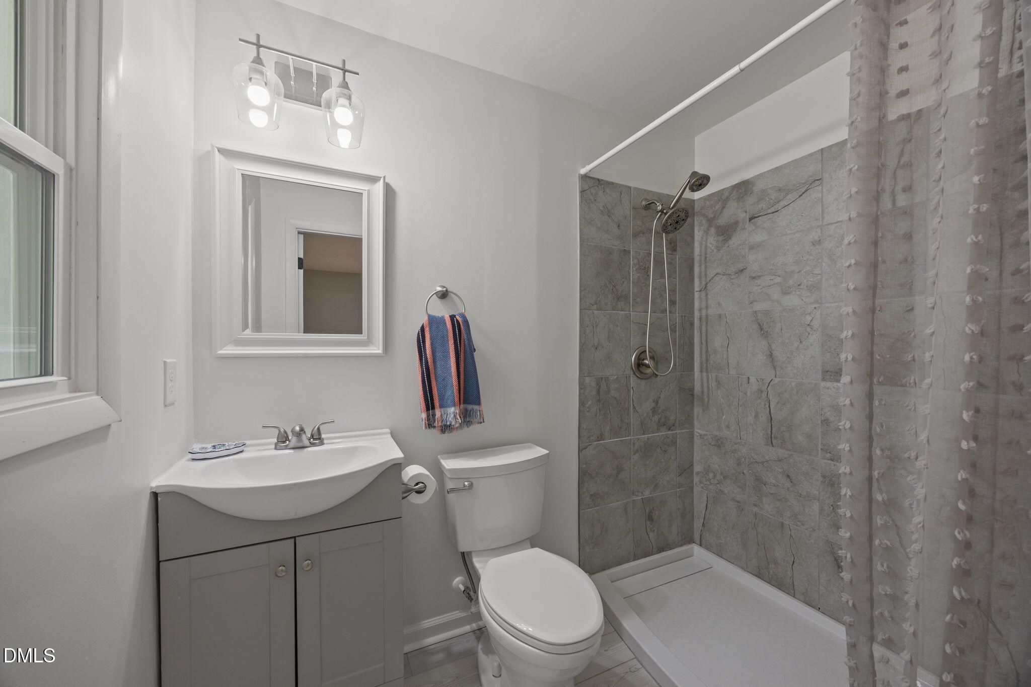 6561 Huntsboro Road Oxford, NC 27565 - Photo 28 of 41 a bathroom with a toilet sink vanity and shower