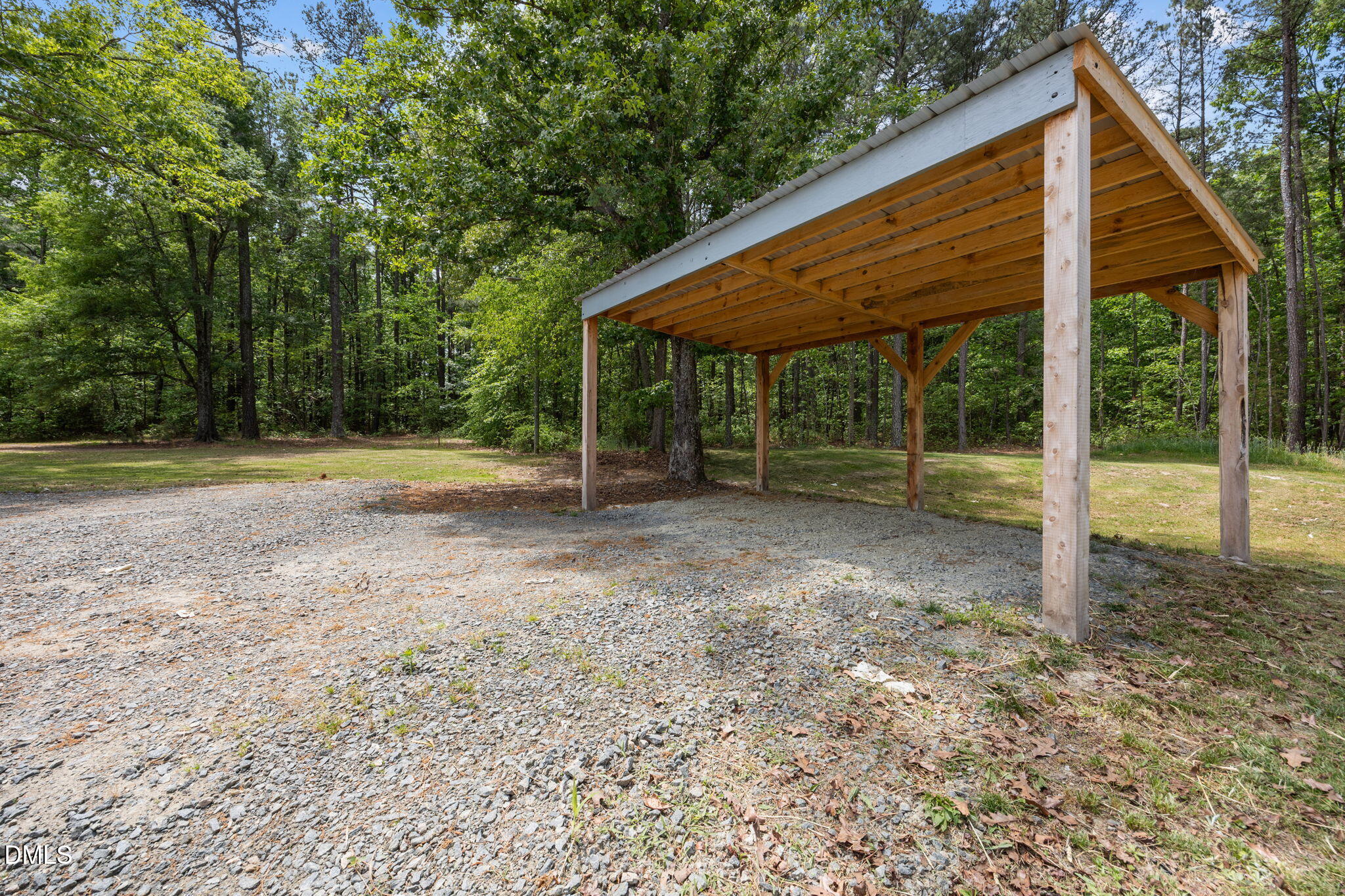 6561 Huntsboro Road Oxford, NC 27565 - Photo 39 of 41 a backyard of a house with plants and large trees