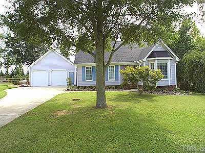 2037 Howson Road Raleigh, NC 27603 - Photo 1 of 1 a front view of a house with a garden and trees