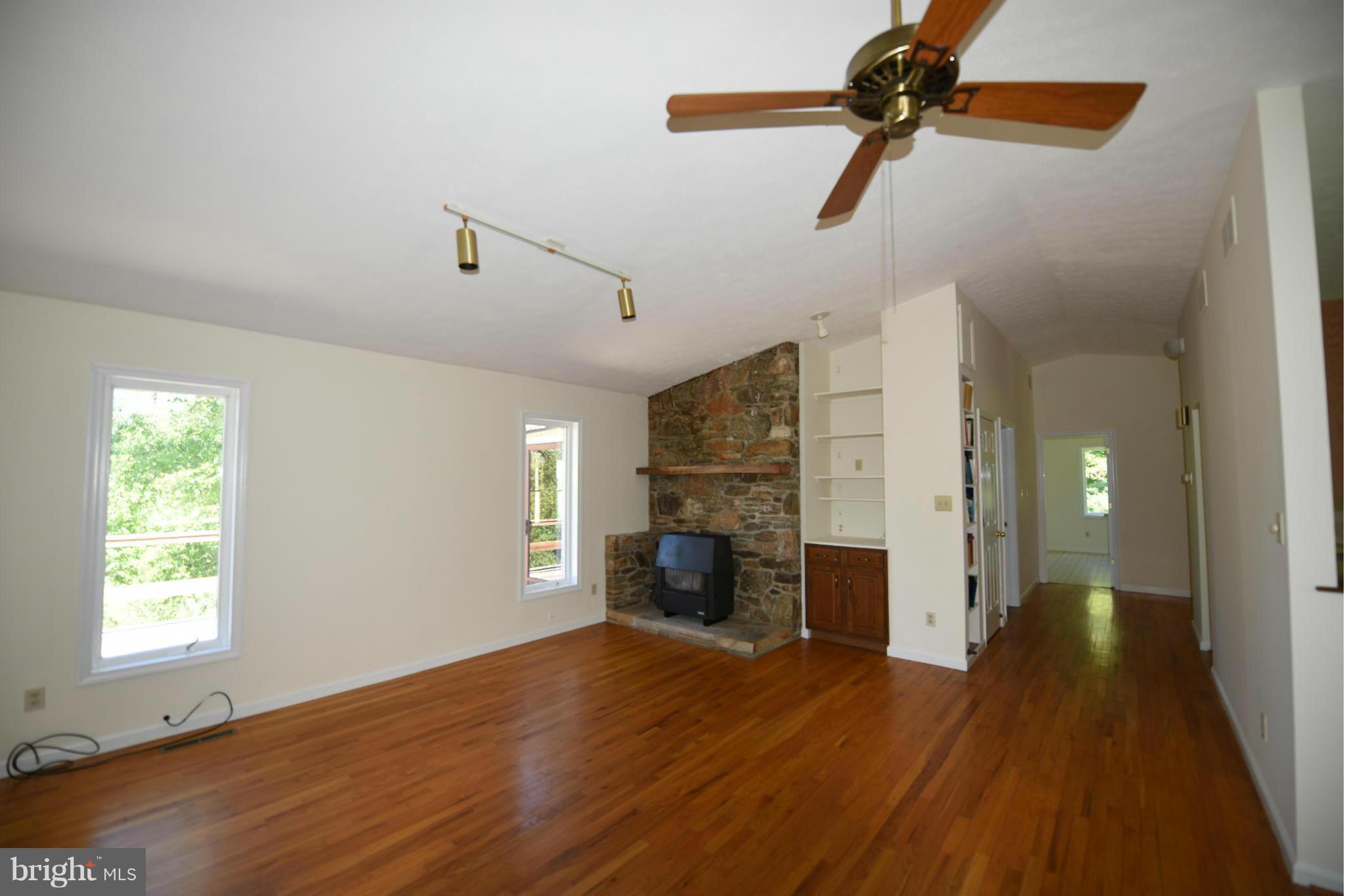 279 Ridgeview Lane Washington, VA 22747 - Photo 5 of 11 a view of empty room with wooden floor and fan