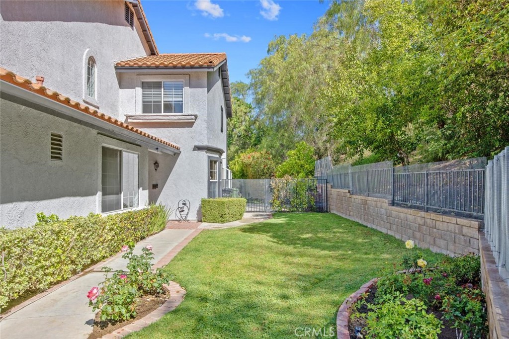5974 Ruthwood Drive Calabasas, CA 91302 - Photo 20 of 30 a view of a house with a yard and flower garden