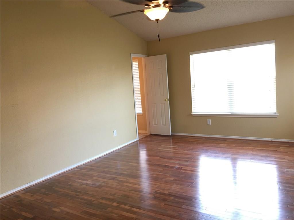 6740 Red Rock Trail Watauga, TX 76137 - Photo 11 of 16 an empty room with wooden floor and windows