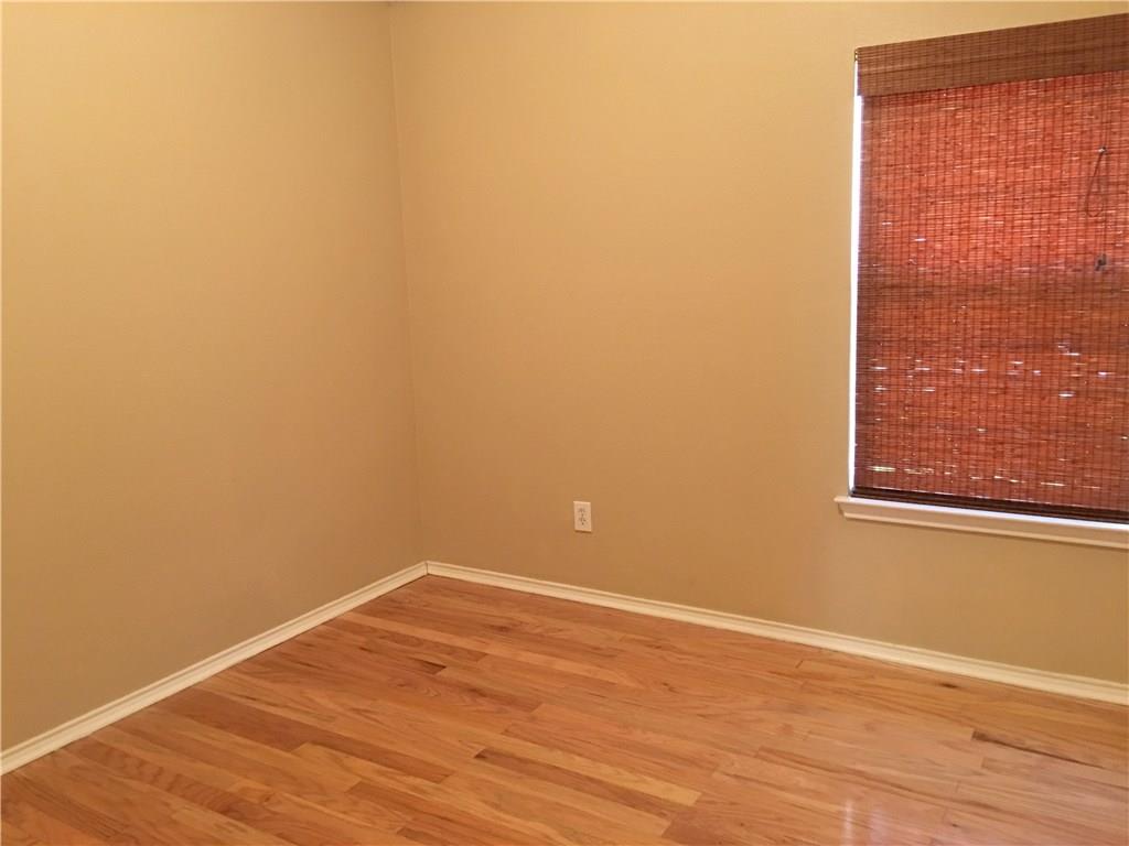 6740 Red Rock Trail Watauga, TX 76137 - Photo 13 of 16 an empty room with wooden floor and windows