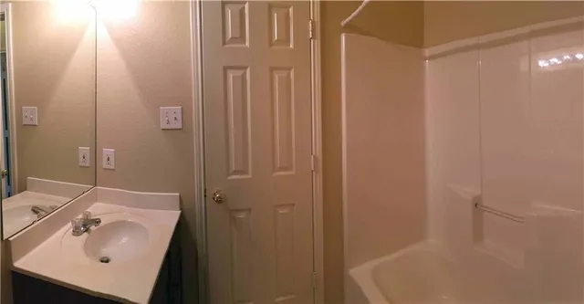 a bathroom with a sink and shower