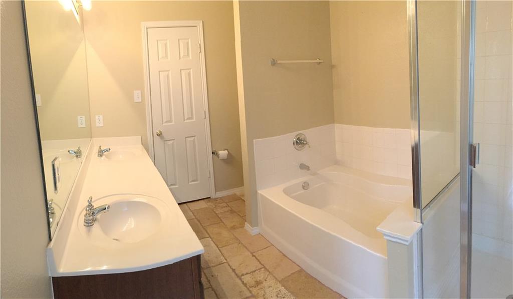 6740 Red Rock Trail Watauga, TX 76137 - Photo 15 of 16 a bathroom with a tub sink and mirror