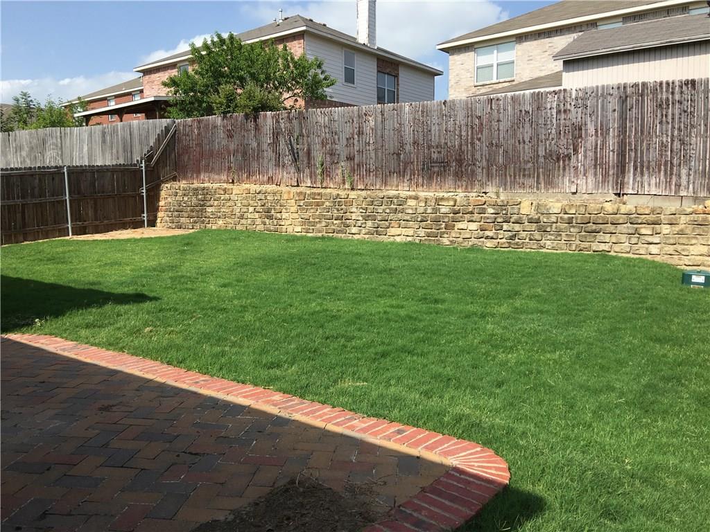 6740 Red Rock Trail Watauga, TX 76137 - Photo 16 of 16 a view of a backyard with small garden