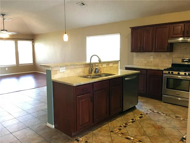 a kitchen with a sink and cabinets