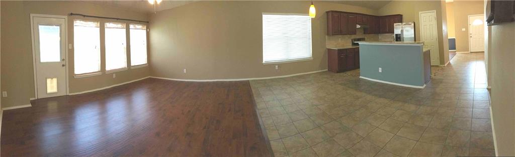 6740 Red Rock Trail Watauga, TX 76137 - Photo 8 of 16 an empty room with wooden floor and windows