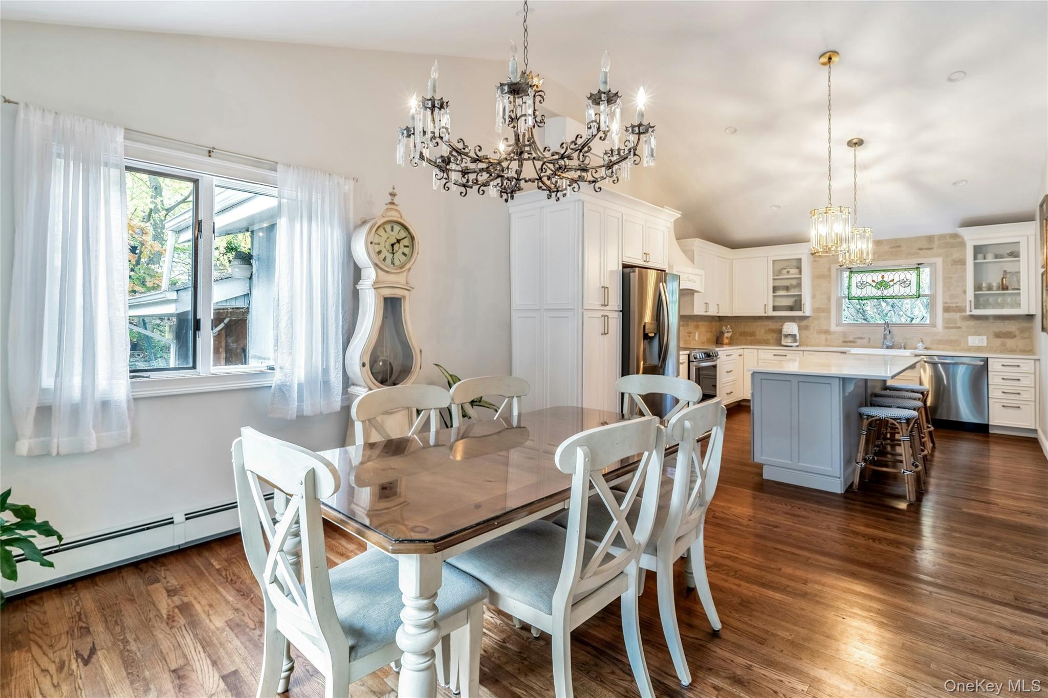 121 Grove Road Kings Park, NY 11754 - Photo 11 of 24 a view of a dining room with furniture a chandelier and wooden floor