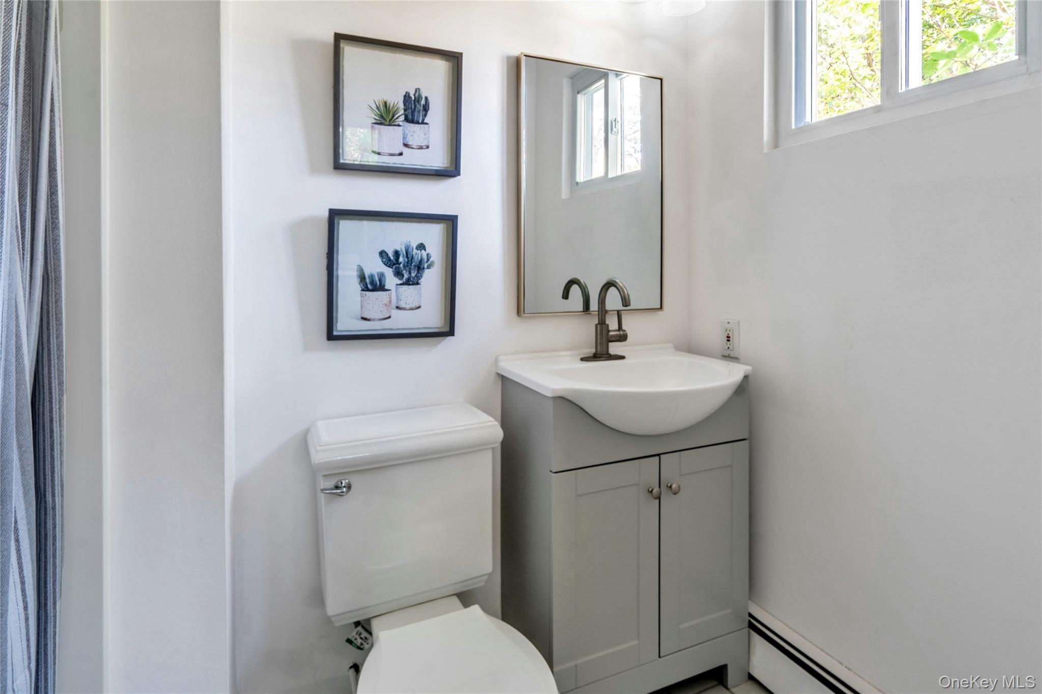 121 Grove Road Kings Park, NY 11754 - Photo 18 of 24 a bathroom with a sink mirror and toilet