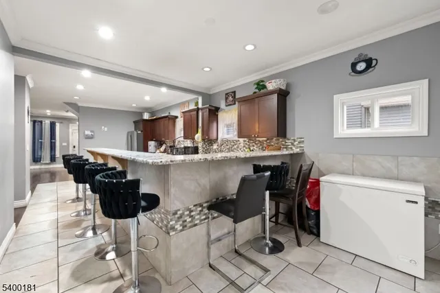 a kitchen with stainless steel appliances kitchen island granite countertop a sink and cabinets