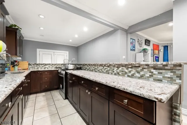 a kitchen with granite countertop a sink and cabinets
