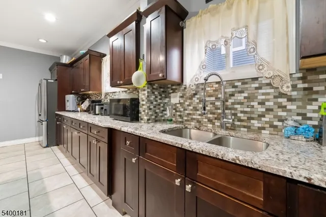 a kitchen with stainless steel appliances granite countertop a sink stove and cabinets
