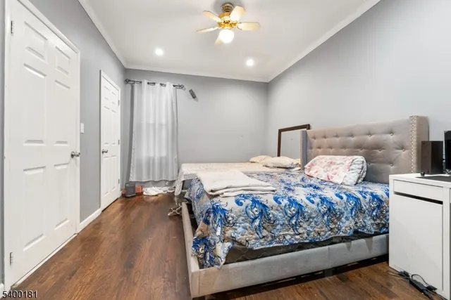 a bedroom with a large bed and a chandelier