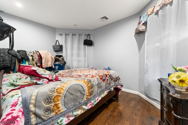 263 Stiles Street Elizabeth, NJ 07208 - Photo 19 of 30 a bedroom with a bed and a tv on the dresser