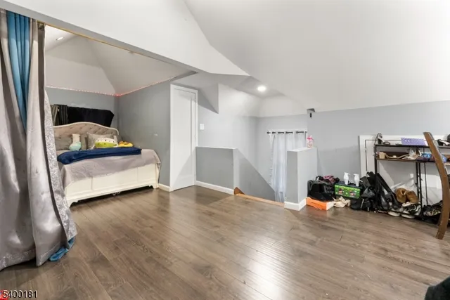 a bedroom with furniture and a wooden floor