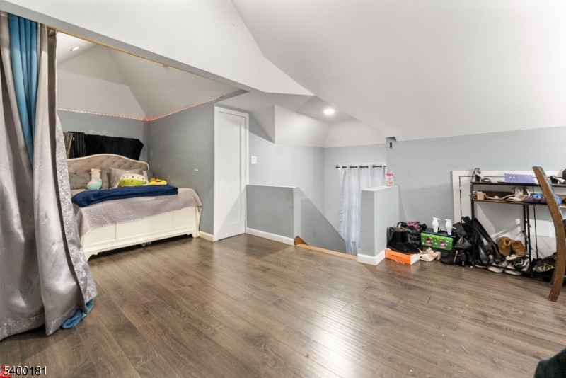 263 Stiles Street Elizabeth, NJ 07208 - Photo 25 of 30 a bedroom with furniture and a wooden floor