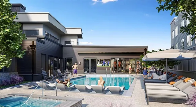 a view of the patio with dining table and chairs under an umbrella with a fountain