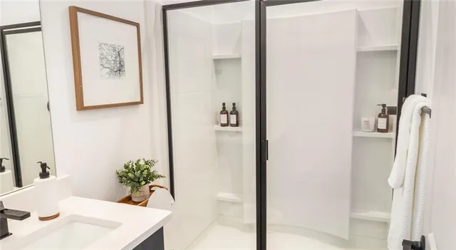 a view of a hallway with furniture and wooden floor