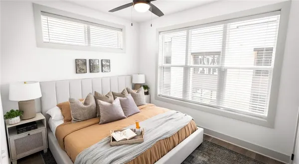a bedroom with a bed and a window