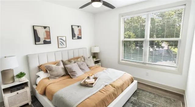 a bed sitting in a bedroom next to a window