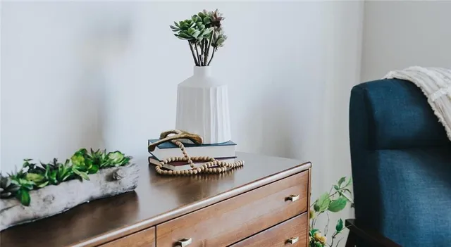 a room with a potted plant on the counter and table