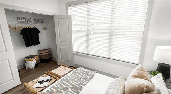 a bedroom with a bed a window and walk in closet