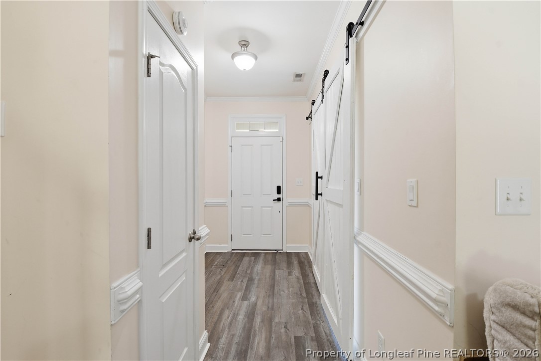 140 Birch Avenue Spring Lake, NC 28390 - Photo 14 of 49 a view of a hallway with wooden floor and a bathroom