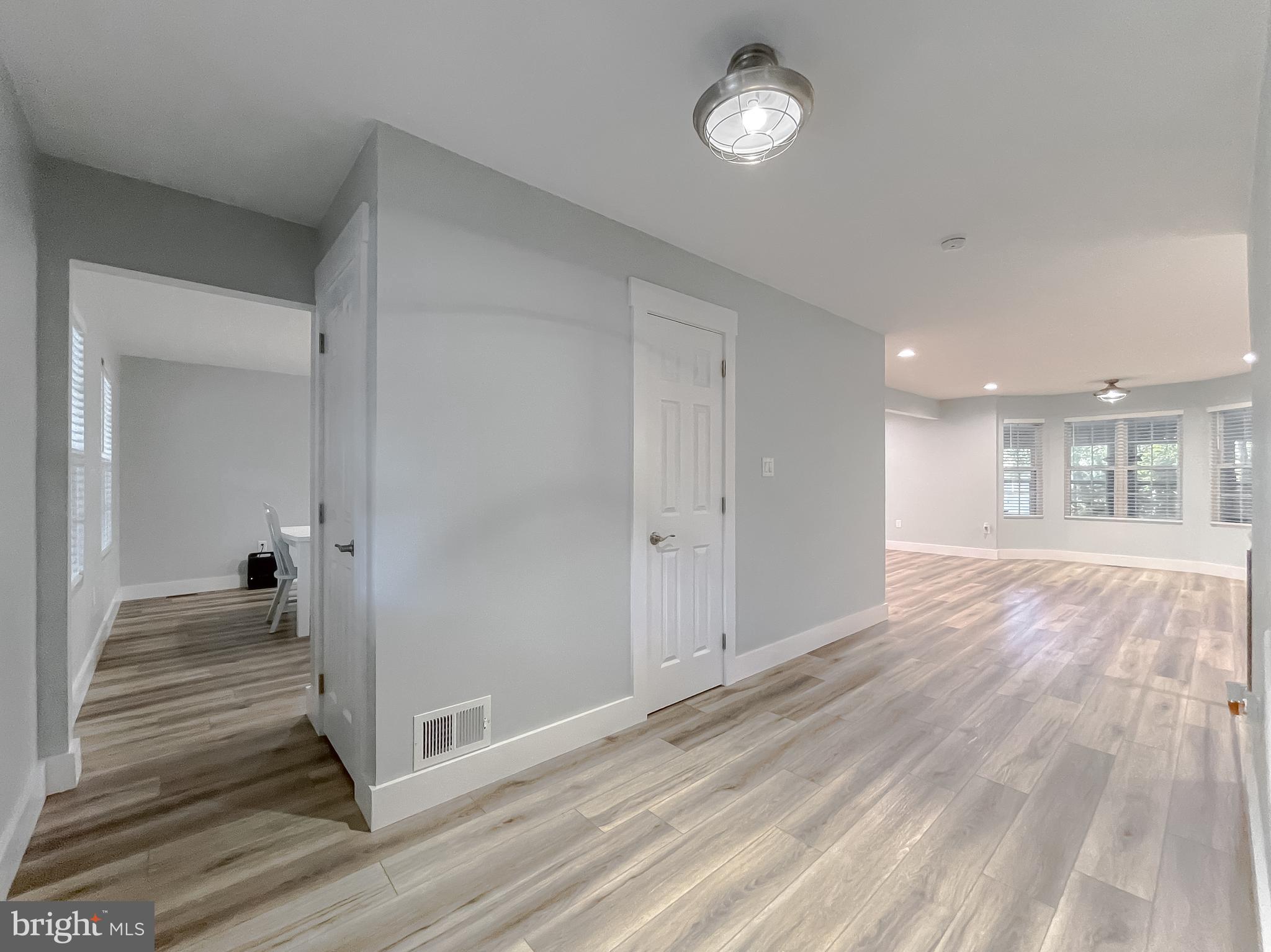 13630 Dowell Road Solomons, MD 20657 - Photo 19 of 121 a view of a hallway with wooden floor and a living room