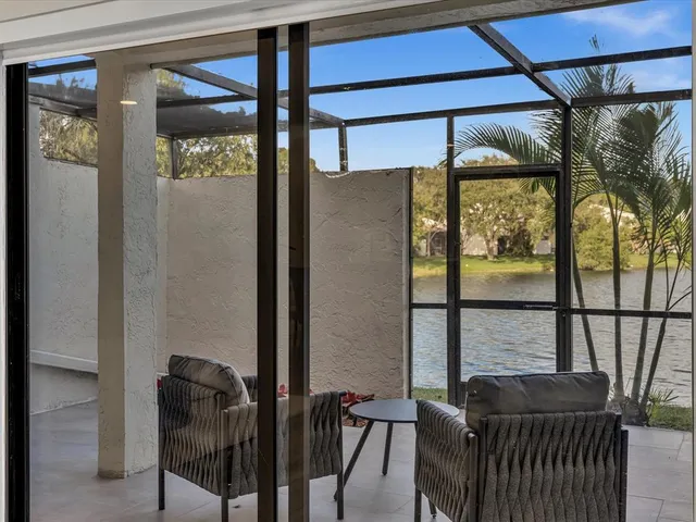an empty room with wooden floor ceiling fan and window