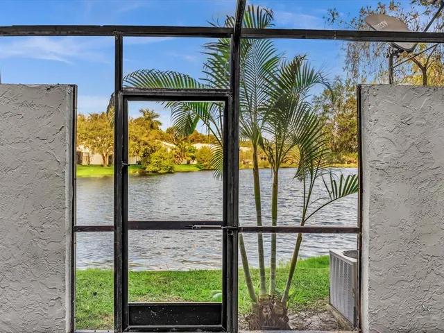 a view of a livingroom with table and chairs with wooden floor