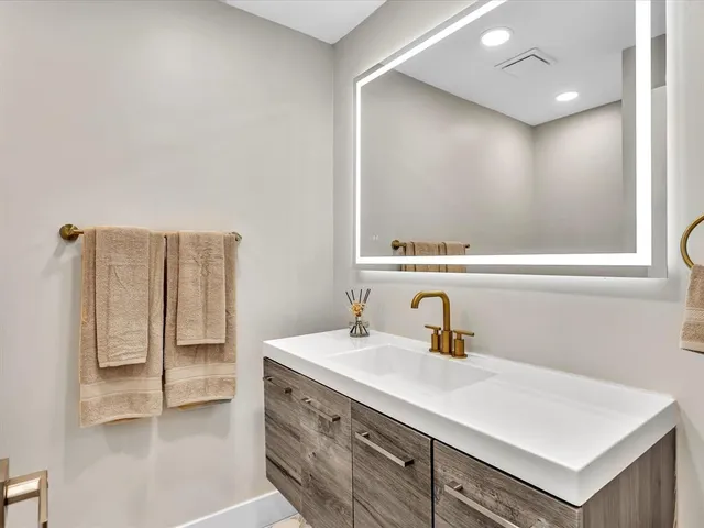 a front view of a house with a yard and plants